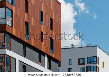 a new Scandinavian-style residential building against a blue sky on a sunny day