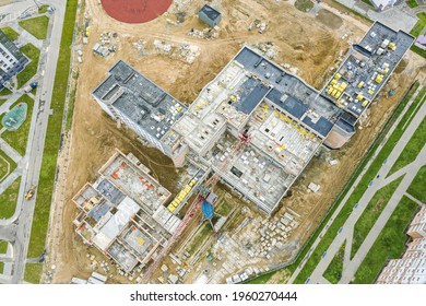 New School Building In Residential Area Under Construction. Roof Construction In Progress. Aerial View