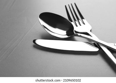 New Shiny Cutlery On Grey Table, Closeup