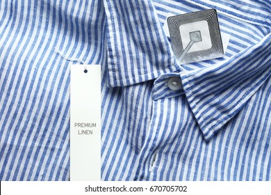 New Shirt And Rfid Sticker Tag Represent Fashion Retail Shoplifting Protection Technology Concept.