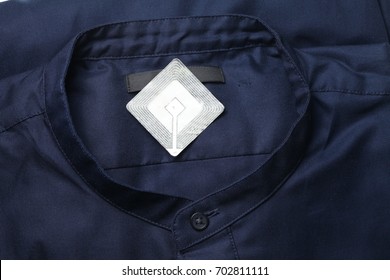 New Shirt And Rfid Sticker Tag Represent Fashion Retail Shoplifting Protection Technology Concept.