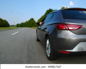 New Silver Car On The Asphalt Road