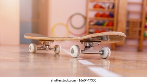 new skateboard stands on wooden parquet against various blurry toys in children room close low angle shot - Powered by Shutterstock