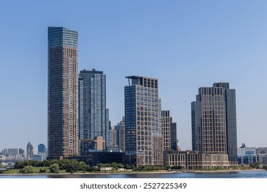 A new skyscraper rises along the waterfront in New York City, highlighting the ongoing urban development in the area. Various nearby building structures reflect a vibrant skyline. - Powered by Shutterstock