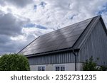 New Solar panels, Photovoltaics on Rooftop generating renewable Electricity in the Swedish Countryside.