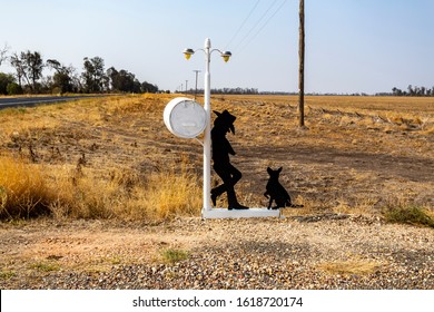 NEW SOUTH WALES, AUSTRALIA – January 7, 2020: Man And His Dog Waiting For Mail On A Side Road In NSW, Australia. Example Of A Great Australian Letterbox With A Sense Of Humor.