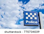 New South wales police station sign with cloudy sky at the background,  is a building which serves to accommodate police officers and other members of staff.