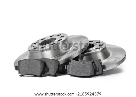 New spare parts for brake repair. Brake discs and brake pads on a white background.