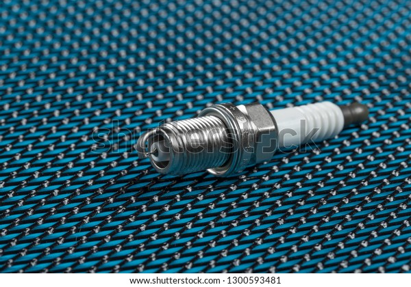 new spark plugs a blue\
background. Studio macro image of high quality. To advertise auto\
service.
