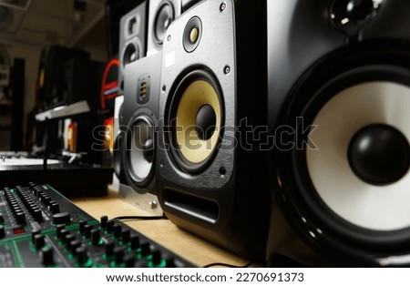 New speakers in music store. Buy professional studio monitors for sound recording. High fidelity speaker box on sale