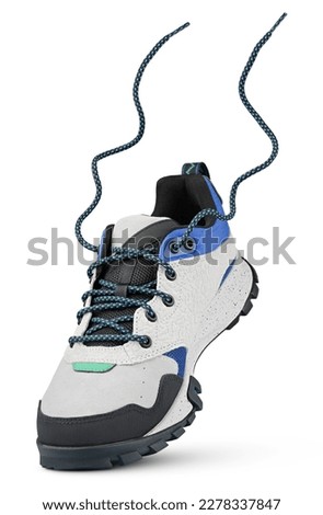 New sports leather boot with flying laces stands on the tip isolated on white background. Trekking shoe with clipping path. Full Depth of Field