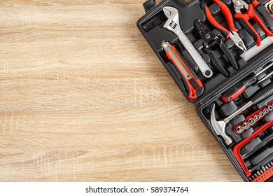 New Square Black Tool Box On Wooden Texture Background. Top View.