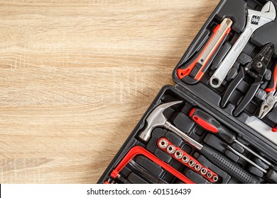 New Square Black Tool Box On Wooden Texture Background. Top View