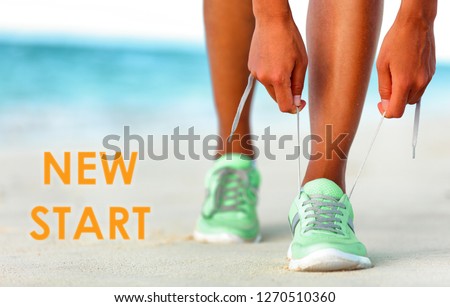 New Start fitness new year resolution runner woman tying up laces of running shoes getting ready to run for weight loss.
