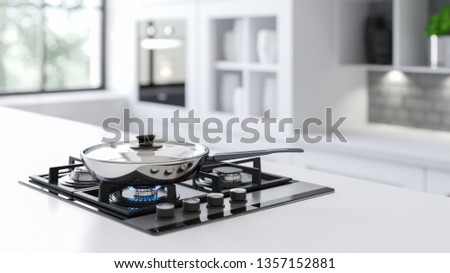 A New steel frying pan on a mirrored black gas stove in a white interior with a large window in the background. Behind The window there is a bright sun and green tree