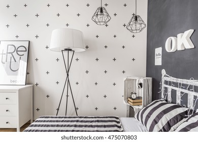 New Style Bedroom With Chalkboard Wall, Pattern Bedding And Simple Floor Lamp