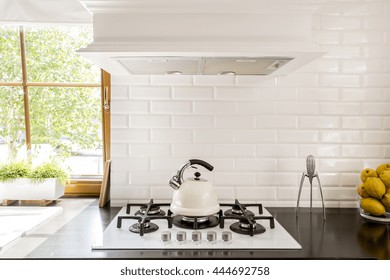 New Style Kitchen With Dark Worktop, White Gas Cooker And Decorative Brick Backsplash