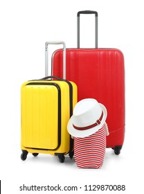 New suitcases, bag and hat packed for journey on white background
