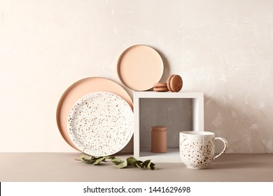 New Tableware On Table Near Grunge Wall