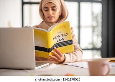 New Tax Law. Young Muslim Girl Learning A Law Using The New Tax Law Book