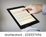 new technologies concept: hands with touchscreen ebook