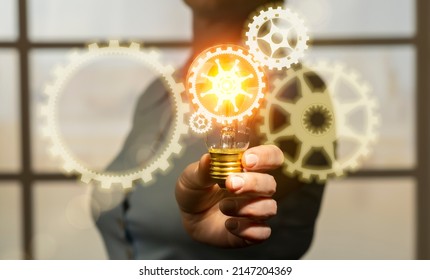 New technology invention concept, engineer in hand holding light bulb with gears icons, innovation and development - Powered by Shutterstock