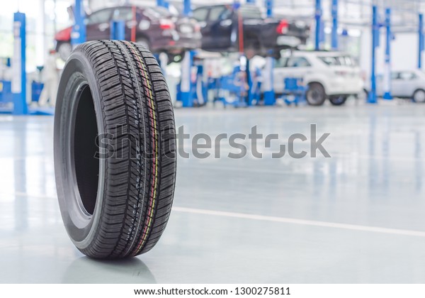 New tires in\
the garage, car lifts,\
background