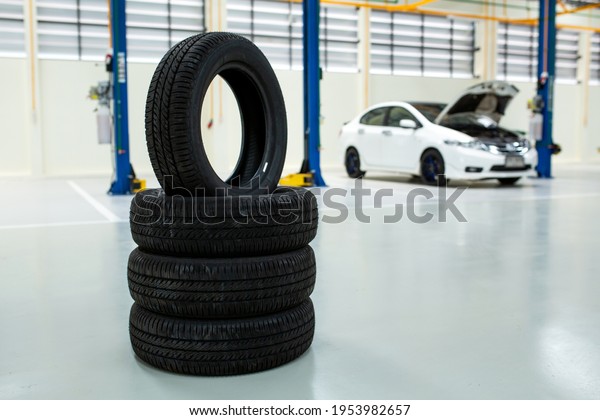 New tires that change tires\
in the auto repair service center, new car tires and blurred\
background