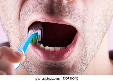 New Tooth Brush On The Background Of The Person. Dental Care