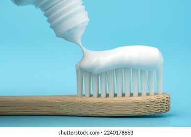 New toothbrush with toothpaste closeup on blue background closeup - Shutterstock ID 2240178663
