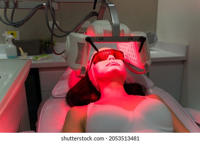 New Treatment For A Healthy Skin. Young Woman With A LED Mask Relaxing At The Beauty Spa