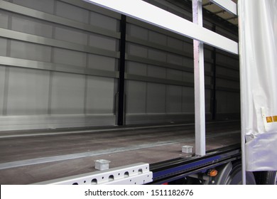 New Truck Empty Semi Trailer With Removable Curtains, Indoor Side View Close-up, Lorry Transportation Logistics With Side Loading