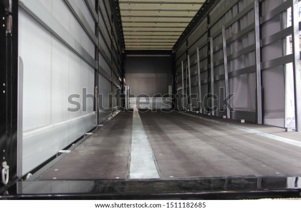 New truck empty semi trailer\
inside rear view close-up, lorry transportation\
logistics