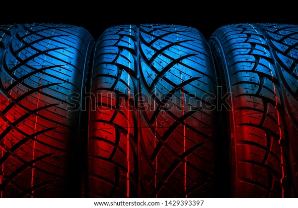 New tyres\
background. Car tyres close\
up