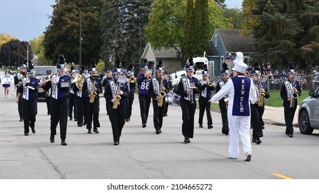 New Ulm, MN USA - 10-01-21 - New Ulm High School Marching Band Eagles In The Homecoming Parade Wearing Their Purple, White And Black Marching Band Uniforms On A Paved City Street