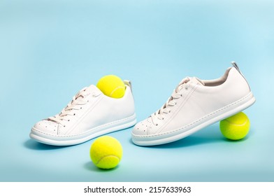 New Unbranded Fancy White Tennis Shoes On Blue Background New Unbranded Sneakers Or Trainers On Blue Background. Men's Sport Footwear. Pair Of Sport Shoes. Copy Space