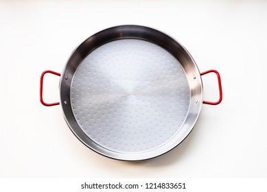 New Unseasoned Carbon Steel Paella Pan Isolated On White Background, Top View