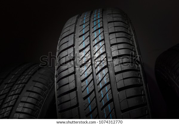 New and
unused car tires against dark
background