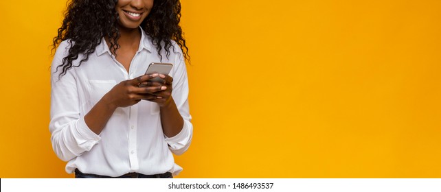 New useful application. Black woman using cellphone on yellow background, free space - Shutterstock ID 1486493537