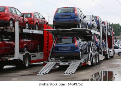 A New Vehicles On Transport Car Carrier Truck - Heavy Duty Auto Transporter Trailer.