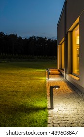New villa with backyard and outdoor lighting, night external view
