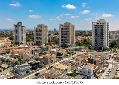 New villas, private houses and residential buildings under blue sky in a new neighborhood of city of Kiryat Gat, Israel.