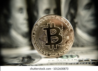 New virtual money Golden bitcoin coin on us dollars background . Cryptocurrency. Business and Trading concept. Close-up shot