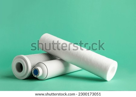 New water filter cartridges on green background