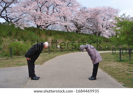 A new way of greeting to avoid the spread of coronavirus (COVID-19). Two Japanese people are bowing instead of hug or handshake. You can keep more distance than elbow bumping.