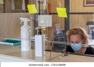 The New Way Of Working Imposed By The Needs To Avoid Possible Contagions From Covid-19 Coronavirus, With Plexiglass Screen And Mask