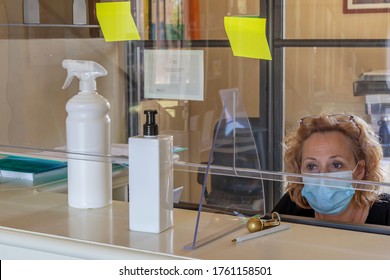 The New Way Of Working Imposed By The Needs To Avoid Possible Contagions From Covid-19 Coronavirus, With Plexiglass Screen And Mask