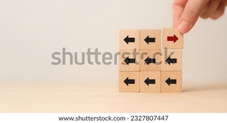 New ways of working, differentiation strategy concept  symbol on wood blocks. Providing uniqueness, different and distinct from competitors, creating competitive advantage. Business direction concept.