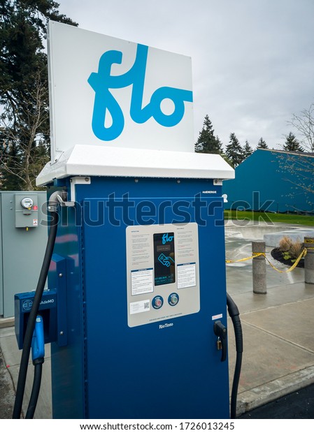 New Westminster, BC / Canada - April 22nd\
2020: a shot of a Flo AddEnergie Chademo and SAE Combo electric car\
fast charging network station located in Queen\'s Park in the royal\
city of New Westminster