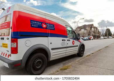 New Westminster, BC / Canada - March 31st 2020: Canada Post Delivery Van Stopped To Drop Off Mail To A Local Neighbourhood Businesses And Residents